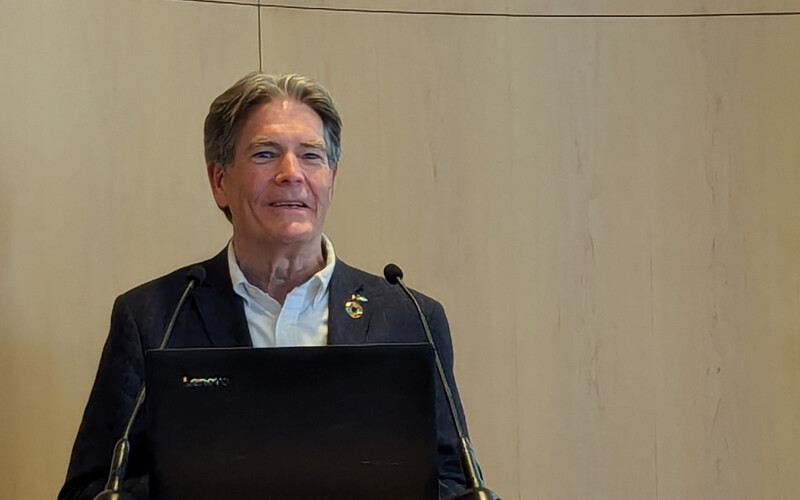 Global Dialogue on Seafood Traceability Executive Director Greg Brown speaking at a podium during Seafood Expo Global