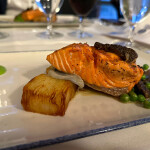 A Copper River salmon fillet on a plate topped with caviar offered by Legal Sea Foods