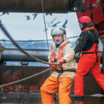 A pair of Polar Seafood fishermen at work on a boat
