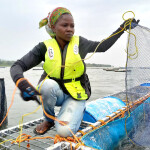 A woman working at an aquaculture farm on Lake Victoria