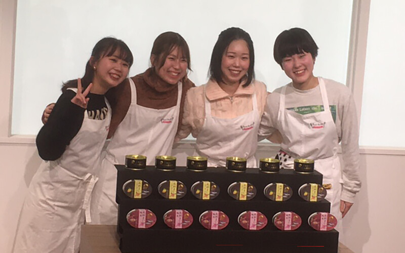 Students at the Shoin Women's College displaying new products created through a partnership with Maruha Nichiro