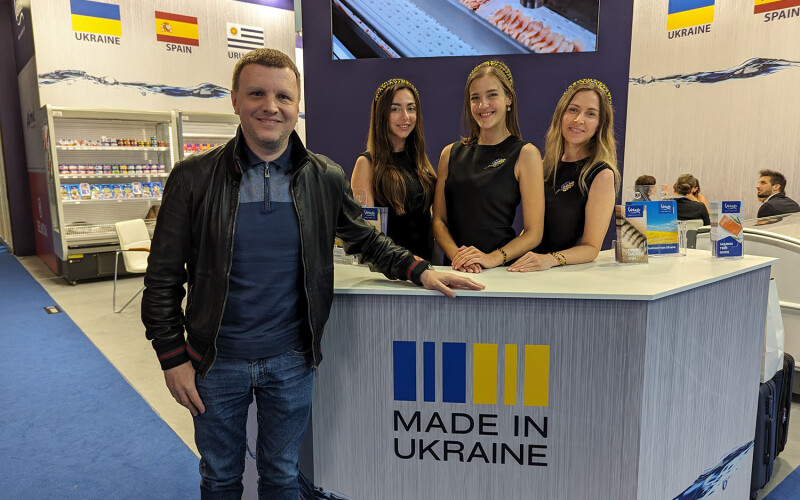 Klion Group CEO and Co-Owner Sergiy Kardash posing with the "Made in Ukraine" label on the company's booth at the 2024 Seafood Expo Global