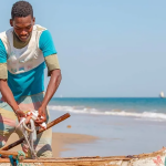 A Benin fisherman readying his boat