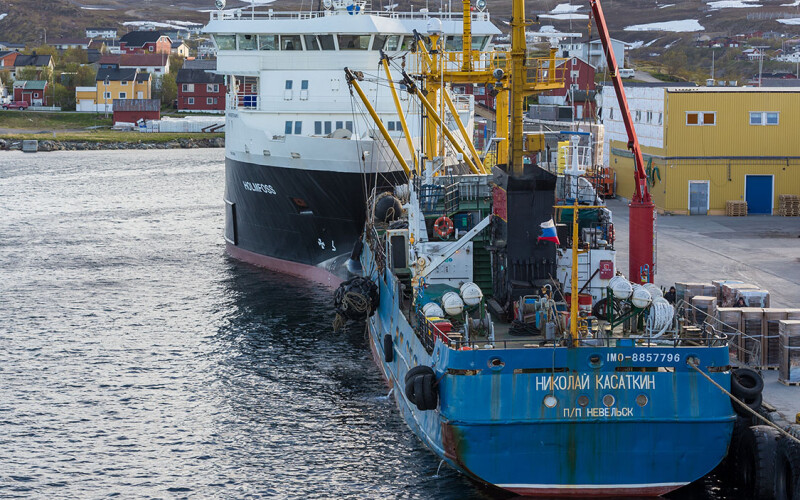 A Russian fishing vessel offloads its catch at the port in Båtsfjord, Norway