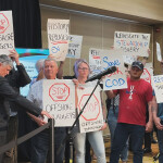 Members of the Fish, Food, and Allied Workers Union disrupting a press conference of Canadian environment ministers