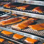 A rack of smoked salmon in a seafood processing facility