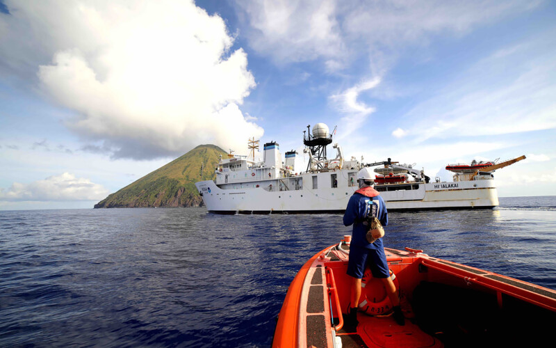 A small boat approaches NOAA Ship Hi‘ialakai at Asuncion Island