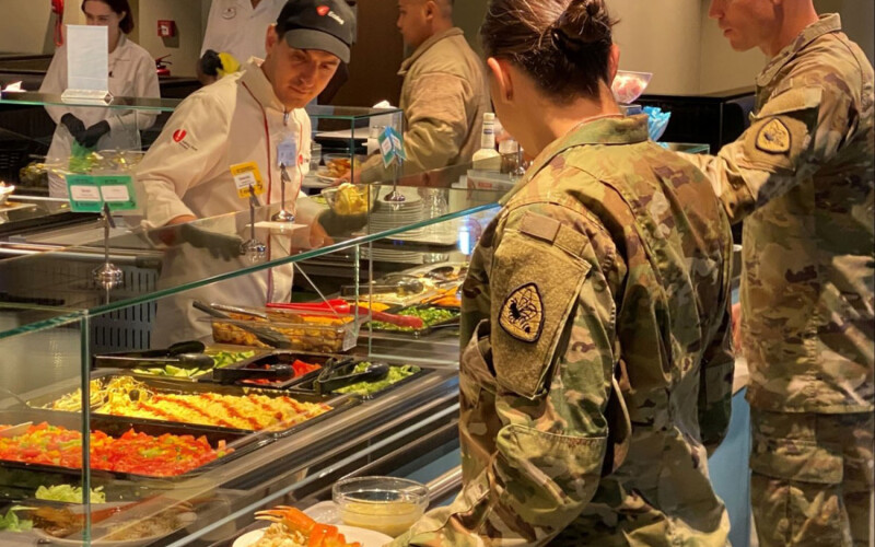 Members of the U.S. army getting food at a salad bar