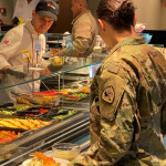 Members of the U.S. army getting food at a salad bar
