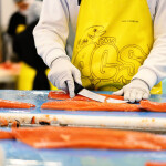 An Alaska Glacier Seafoods fish-cutter at work
