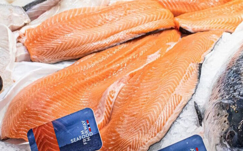 Fillets of salmon sitting on a bed of ice featuring a small "Seafood From Norway" placard