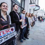 Mercy for Animals protestors outside of a Tesco location with signs decrying cruel animal-slaughter methods