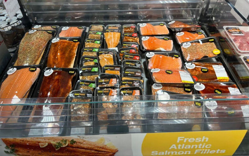 Packaged fresh and flavored salmon fillets at a grocery store