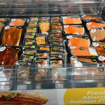 Packaged fresh and flavored salmon fillets at a grocery store