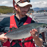 A Multi X farmer holding a salmon grown on one of the company's farms
