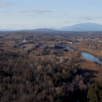 An aerial view of the proposed site for Great Northern Salmon's salmon RAS project, with Mt. Katahdin in the background