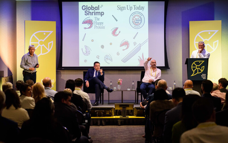 Panelists speaking on stage at the 2024 Global Shrimp Forum