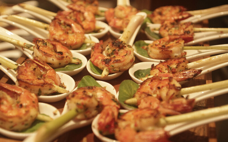 Shrimp skewers presented on soup spoons