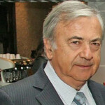 Former Australis owner Isidoro Quiroga, wearing a grey suit.