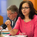 Marcia Eugenio speaking into a microphone at a congressional hearing