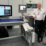 GreenFox Marine General Manager Erling Aspen and a colleague standing next to an advanced computing system