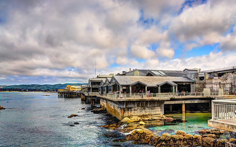 An exterior shot of the Monterey Bay Aquarium, highlighting its proximity to the waters of Monterey Bay