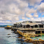 An exterior shot of the Monterey Bay Aquarium, highlighting its proximity to the waters of Monterey Bay