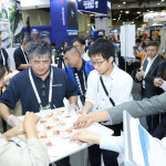Participants at the 2024 Seafood Expo Global tasting a seafood cup