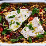A photo of a dish containing baked Norwegian cod and cherry tomato orzo