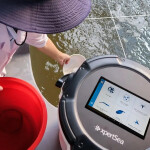 A photo of a fish farmer using XpertSea's XperCount technology, which offers an accurate count of microorganisms, such as fish or shrimp larvae, in a pond in just seconds.
