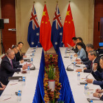 Australian Prime Minister Anthony Albanese at a table across from Chinese Premier Li Qiang during trade meetings in Laos