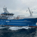 A blue-colored Russian fishing vessel at sea.