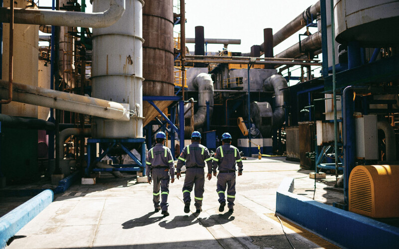 Workers for Copeinca walking together inside a fishmeal production facility