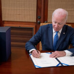U.S. President Joe Biden signing a document