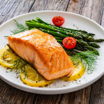 A plate with salmon and asparagus on it
