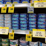 Cans of tuna from StarKist, Chicken of the Sea, and Bumble Bee on store shelves
