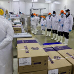 Workers on protective clothing inside a Blumar processing facility