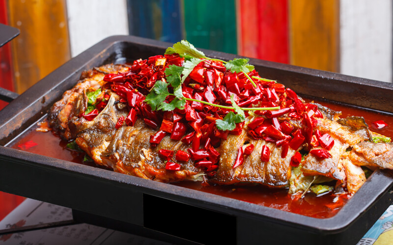 A grilled fish prepared in a Sichuan style