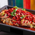 A grilled fish prepared in a Sichuan style