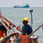 An Ocean Harvesters employee on a fishing vessel