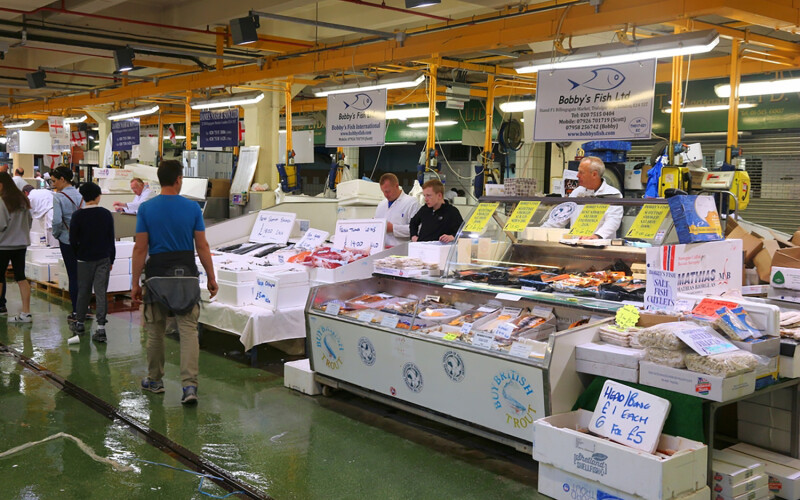 Vendors at the Billingsgate Fish Market in London selling locally produced seafood