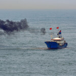 A Chinese fishing trawler spewing out black smoke