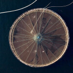 An aerial shot of a Mowi salmon net pen