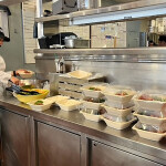 A Santa Monica Seafood employee preparing meals for victims of the Los Angeles area fires