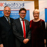 Members of the UK Seafood Federation in front of a banner featuring the new organization's logo