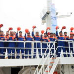 Fishermen on a fishing vessel in Peru celebrate a successful anchoveta season