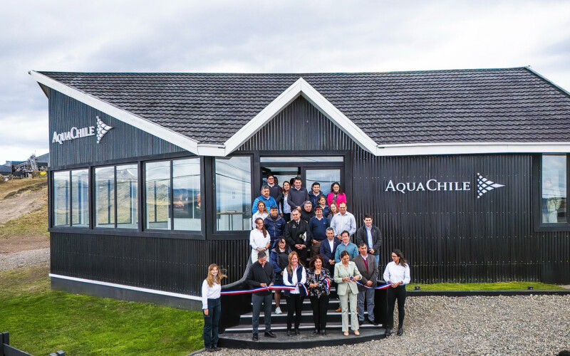 AquaChile employees celebrating the opening of an office where people can learn about the history and impact of salmon farming