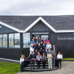 AquaChile employees celebrating the opening of an office where people can learn about the history and impact of salmon farming