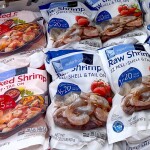 A set of frozen shrimp packages inside a display case