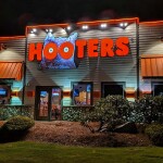 The exterior of a Hooters restaurant at night